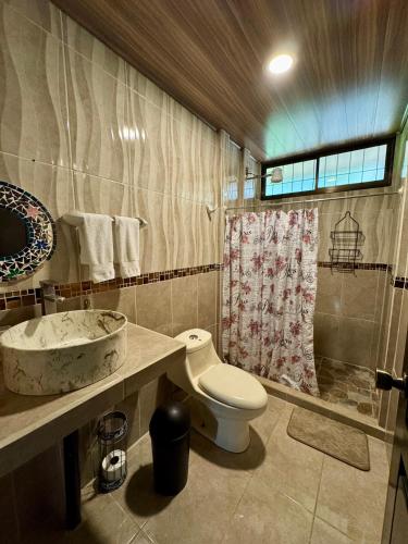 a bathroom with a toilet and a sink at Arboleda House by the River, Forest with Jacuzzi and A C in San Francisco