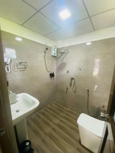 a bathroom with a shower and a toilet and a sink at Trump House in Anuradhapura