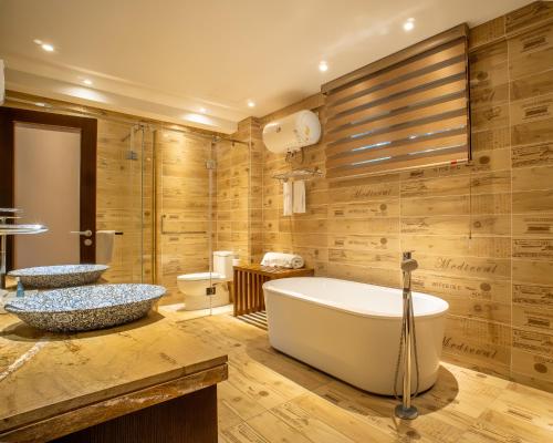 a bathroom with two sinks and a tub at H Resort Bohol - The Coral Cliff by SMS Hospitality in Calape