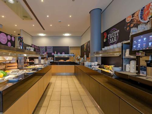 a fast food restaurant with a long line of counters at Mercure Hotel Berlin City in Berlin