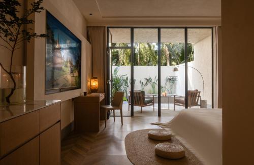 a bedroom with a bed and a table and chairs at Silver Beach Yuese Hostel in Beihai