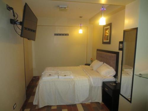 a bedroom with a bed with two towels on it at Hospedaje con recojo in Lima