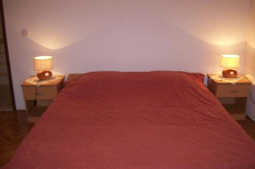 a bedroom with two nightstands with a bed and two lamps at Captain's villa in Molunat