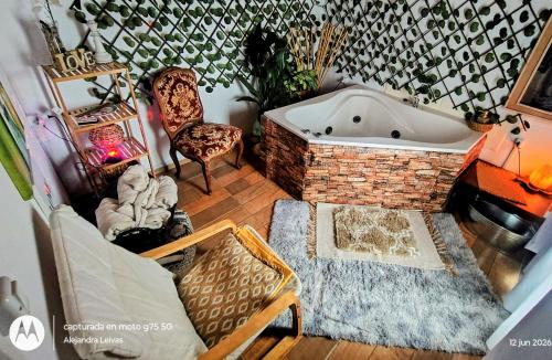 a bath tub in a room with a couch and a chair at Reina Mar Jacuzzi Exclusivo in Barra de Portezuelo