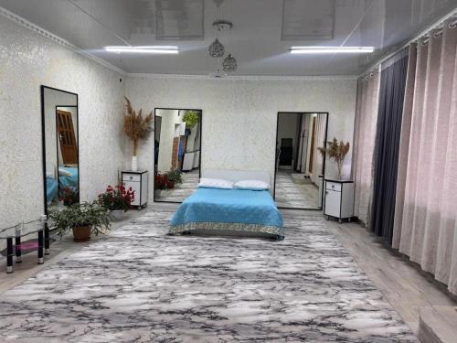 a bedroom with a bed in the middle of a room at Friendly House in Bokonbayevo
