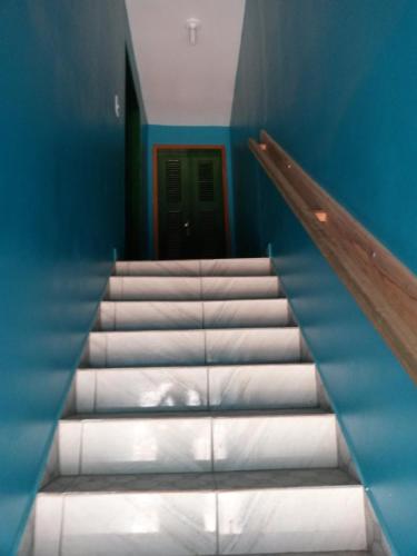 a set of stairs in a room with a door at Suíte central Pousada in Jijoca de Jericoacoara
