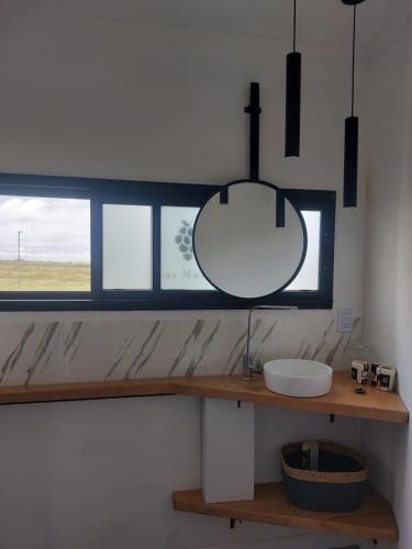 a bathroom with a sink and a mirror on a counter at Las moras quinta in San Nicolás de los Arroyos