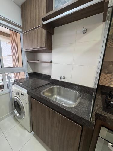 a kitchen with a sink and a washing machine at Casa Luna in Americana
