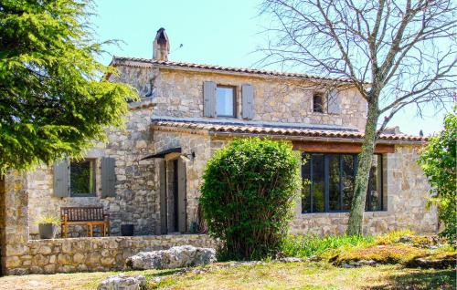 a stone house with a bench in front of it at Stones House in Labeaume
