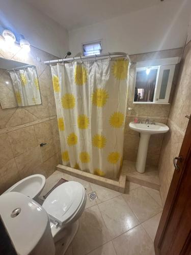 a bathroom with a toilet and a shower curtain at El Chaparral Villa Dolores Traslasierra 2 in Piedra Pintada