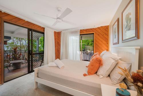 a bedroom with a bed and a balcony at 15 Derby Road Moffat Beach in Caloundra