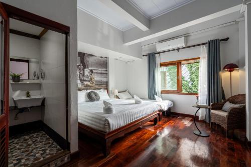 a bedroom with a large bed and a mirror at BlueHome Vientiane in Vientiane