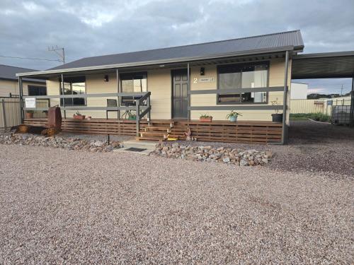 a house with a porch and a gravel driveway at Wudinna Farm View in Wudinna