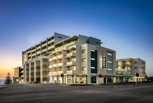 a large apartment building in a parking lot at Quest Scarborough in Perth
