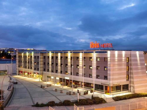a big building with a sign on top of it at Ibis Madrid Alcobendas in Alcobendas