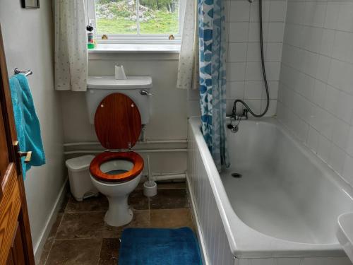 a bathroom with a toilet with a wooden seat at Strathnoon in Inverness