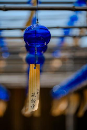 a blue light with a tag hanging from a ceiling at soyo-ne kyoto sanjo in Kyoto