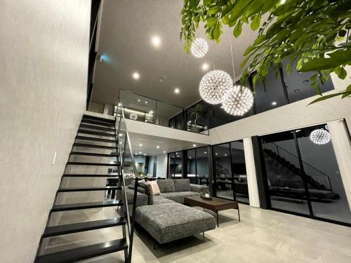 a house with a staircase leading up to a living room at CIN Garden Terrace in Futtsu