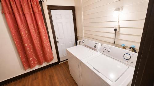 a small laundry room with a washer and dryer at Charming 3 Bdr Home 8 mins from the Falls in Niagara Falls