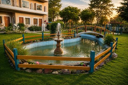 a fountain in the middle of a yard at Kadamb Kuteer Hotel and Resort in Chhatikara