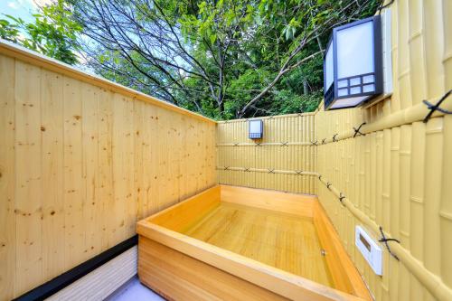 a wooden privacy fence with a wooden floor and a window at Retreat Camp Mahoroba in Fujikawaguchiko