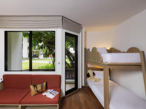 a small room with a bunk bed and a window at ibis Samui Bophut Hotel in Bophut
