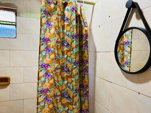 a shower curtain in a bathroom with a mirror at LOLI Guest House Iguazú Habitaciones privadas con baño in Puerto Iguazú