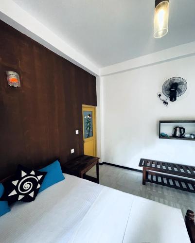 a bedroom with a bed and a yellow door at Samadhi Nature Resort in Ella