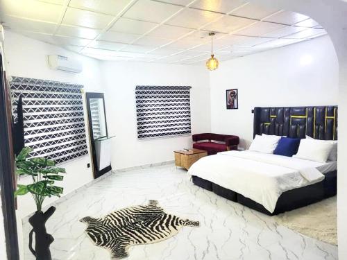 a bedroom with a bed and a zebra laying on the floor at G Spot Hotel in Port Harcourt