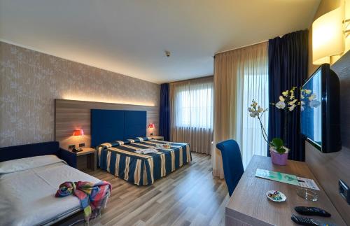 Postel nebo postele na pokoji v ubytování Hotel Alberi