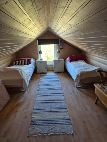 a room with two beds and a rug in a tent at Villa Myklebostad in Sand