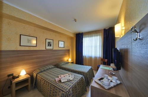 Postel nebo postele na pokoji v ubytování Hotel Alberi