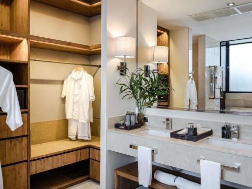 a bathroom with a sink and a mirror at V Villas Hua Hin - MGallery Collection in Hua Hin