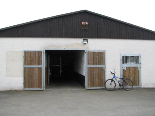 a bike parked in front of a garage at Reiterhof & Pension Lienemann in Grünbach