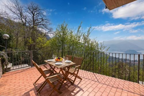 a table and chairs on a patio with a view at Alto Perledo Terrazzo in Perledo