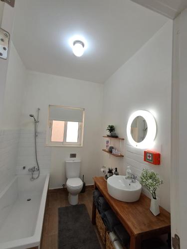 a bathroom with a sink and a toilet and a tub at Lanyard Hitch Court in Marsaxlokk