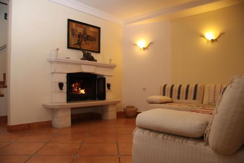 a living room with a fireplace and a couch at Villa Rustika in Sutivan