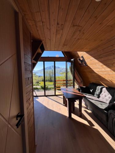a room with a bed and a table and a window at Aurora Cottage Tabatskuri Lake in Tabatsquri