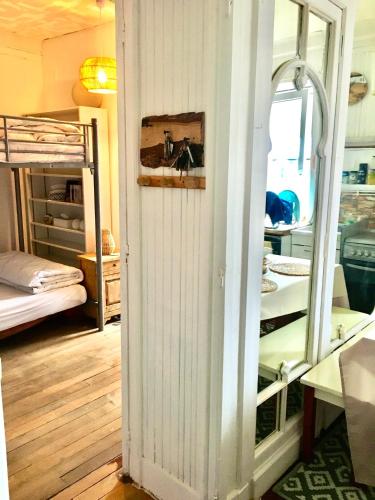 a room with a door leading to a bedroom with bunk beds at T2 Hyper centre le mont dore face thermes et cure in Le Mont-Dore