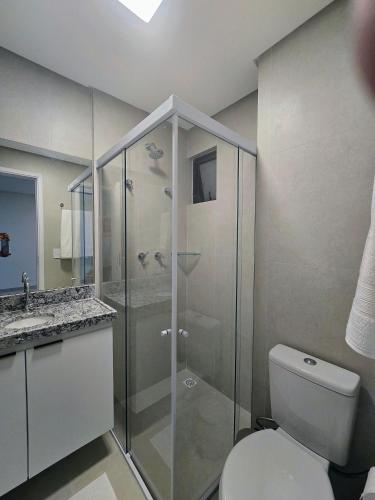 a bathroom with a toilet and a glass shower at Life Center in Caruaru