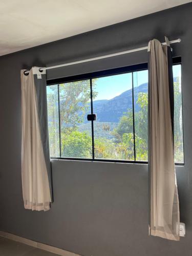a window with a view of a mountain at Casa Jatobá in Ibicoara