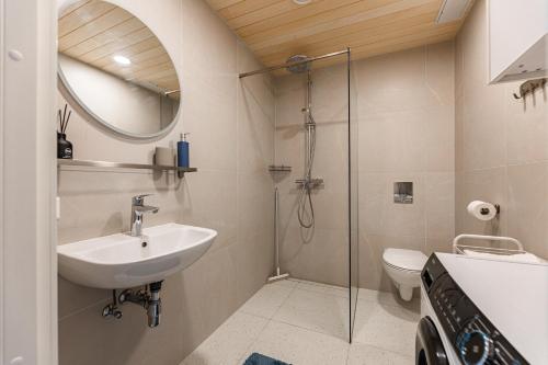 a bathroom with a sink and a shower at Komandandi City Center Apartments in Kuressaare