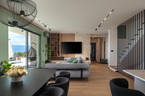a living room with a couch and a tv at Villa Dujma Pool & Spa in Kostrena