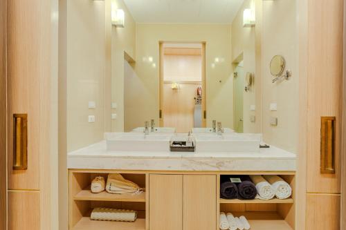 a bathroom with a sink and a large mirror at Andaman Pool Villas, Maikhao Beach Phuket in Mai Khao Beach
