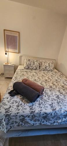 a bed with a blue and white comforter on it at Apartment with private pool in Njivice