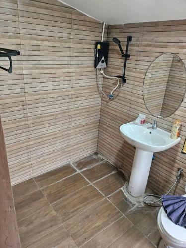a bathroom with a sink and a mirror and a toilet at Rim Tarn Phu View Chiang Mai in Ban Khanin Tai