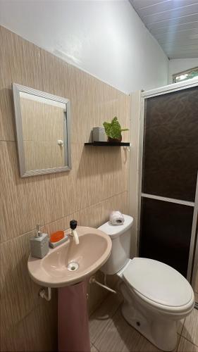 a bathroom with a toilet and a sink at Casa Maré in Soure
