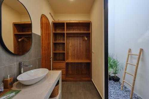 a bathroom with a sink and a mirror at Rest U Guest House in Nusa Penida