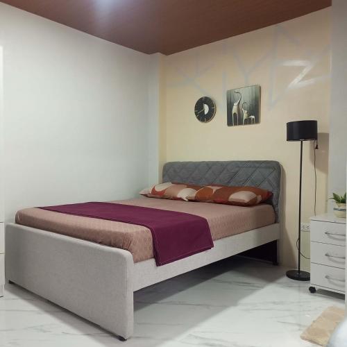 a bedroom with a bed in a white room at Engil's Studio in San Jose Dinagat Islands Philippines in Bulawan