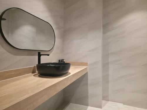 a bathroom with a black sink and a mirror at Casa By The Sea in Bangrak Beach